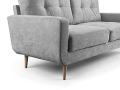 Aurora armchair close-up of tufted back, cushioned seat and wide upholstered arm