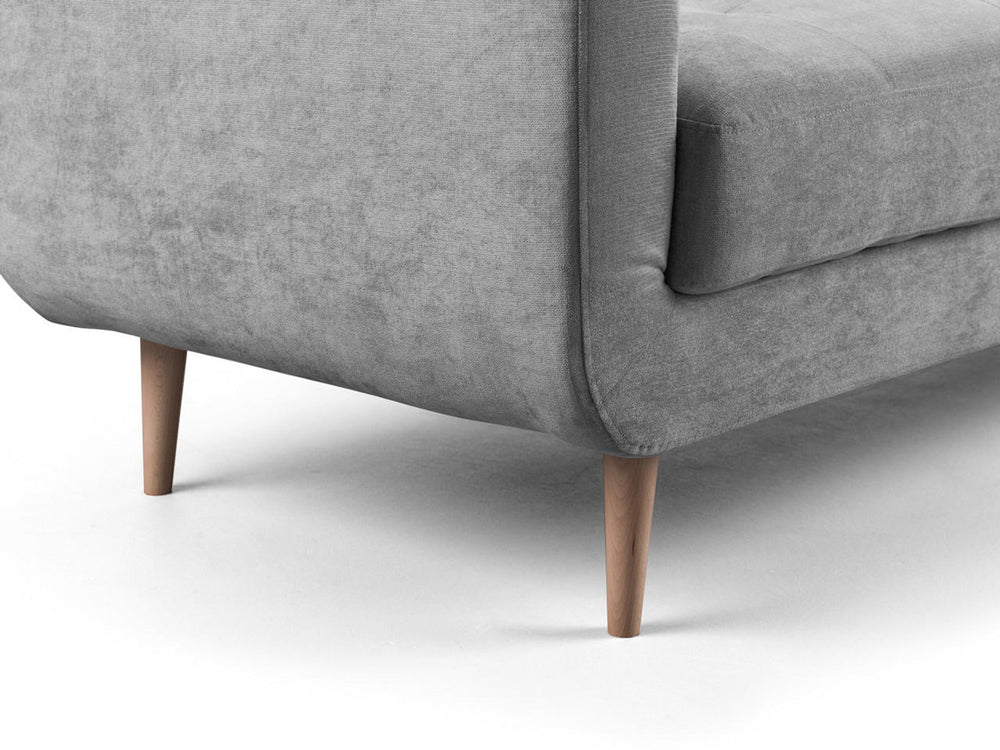 Gray sofa corner detail showing the upholstered arm and tapered wooden legs