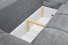 Interior frame and support structure visible beneath the grey sofa bed cushions