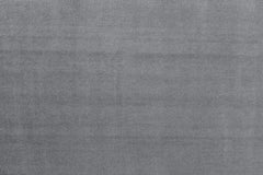 Close-up of the grey sofa bed's woven upholstery fabric