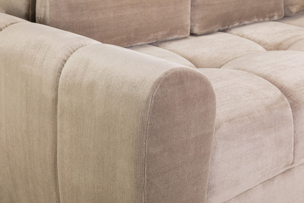 Close-up of the sofa bed's rounded upholstered arm and cushioned seat
