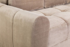 Close-up of the sofa bed's rounded upholstered arm and cushioned seat