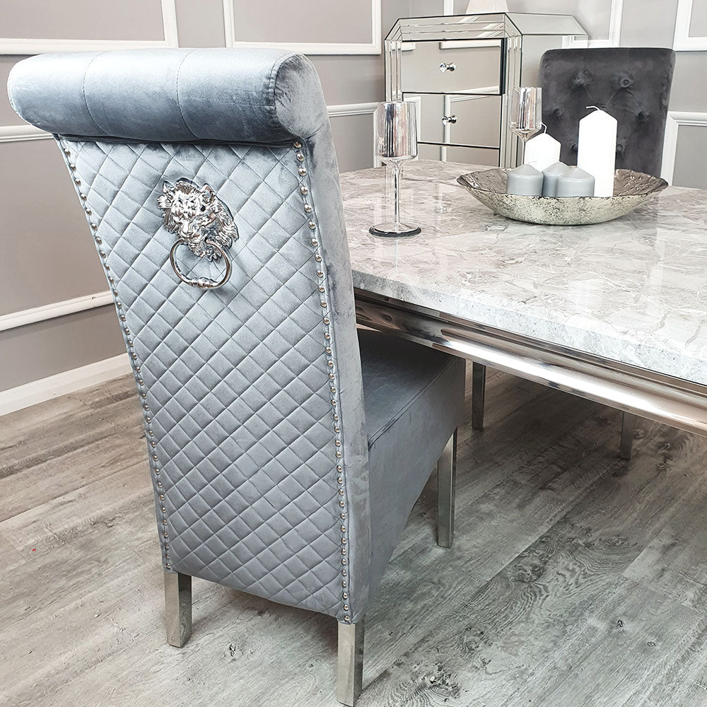Dining chair with light grey velvet, diamond-quilted back, nailhead trim and metal ring pull