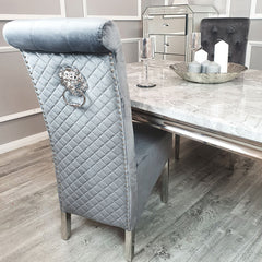 Dining chair with light grey velvet, diamond-quilted back, nailhead trim and metal ring pull