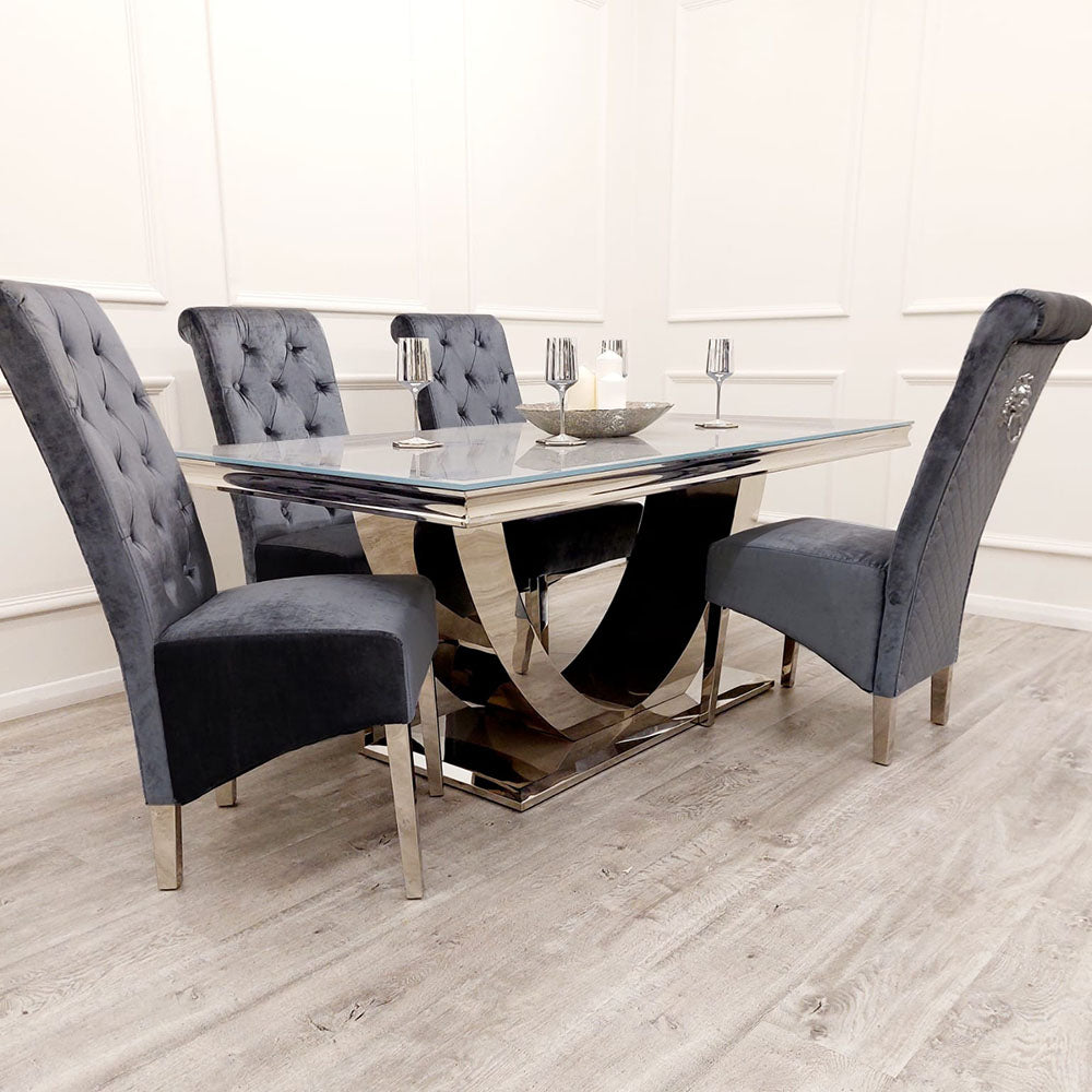 Grey velvet dining chairs with tufted backs and metal legs around a dining table
