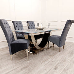 Arial dining table with pale top and curved metallic base, surrounded by tufted chairs
