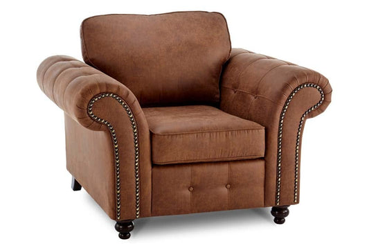 Oakland brown upholstered armchair with rolled arms, nailhead trim and turned legs