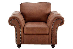 Front view of brown upholstered armchair with rolled arms and nailhead trim