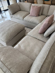 Large corner sofa and matching footstool with cushioned seats