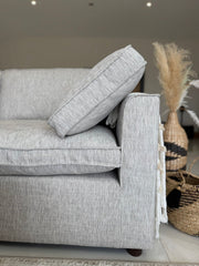 Sofa arm with a loose cushion resting at an angle