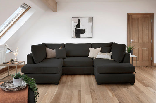 Dark charcoal U-shaped fullback sofa arranged in a living room