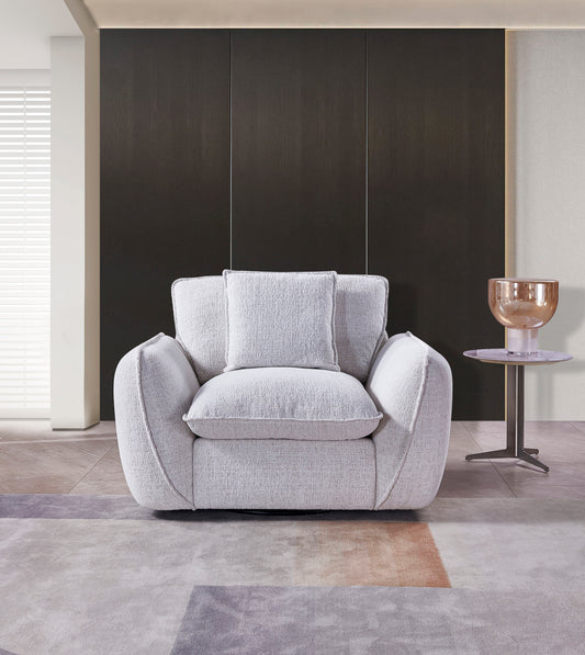 Front view of the Berlin Fullback armchair with broad arms and plush light gray cushions.
