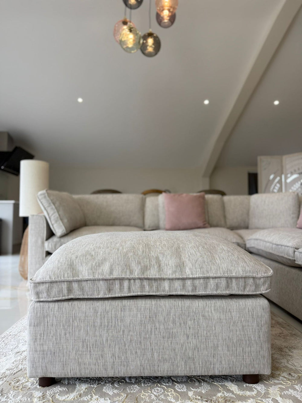 Matching upholstered footstool with a thick cushioned top