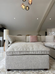 Matching upholstered footstool with a thick cushioned top