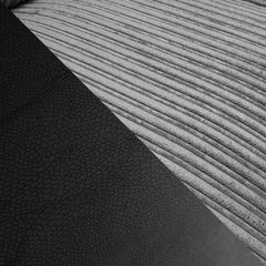 Close-up of ribbed gray upholstery beside textured dark sofa material