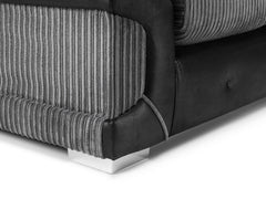 Close-up of ribbed gray upholstery, dark sofa base, and chrome foot