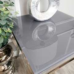 Louis lamp table with a smooth reflective glass tabletop