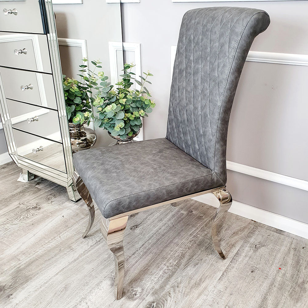 Gray leather dining chair with a tall quilted back, padded seat, and curved metal legs