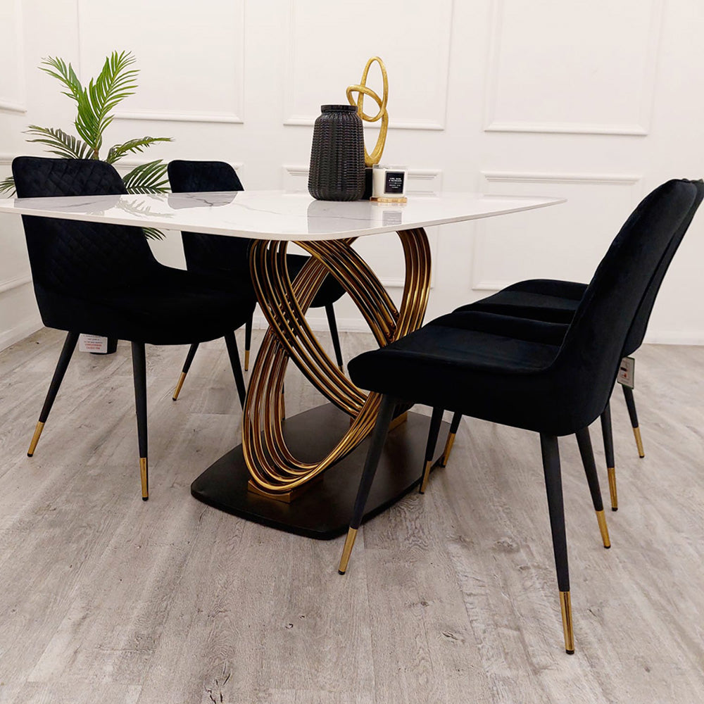 Dining table with rounded white veined top and intertwined gold-tone pedestal base