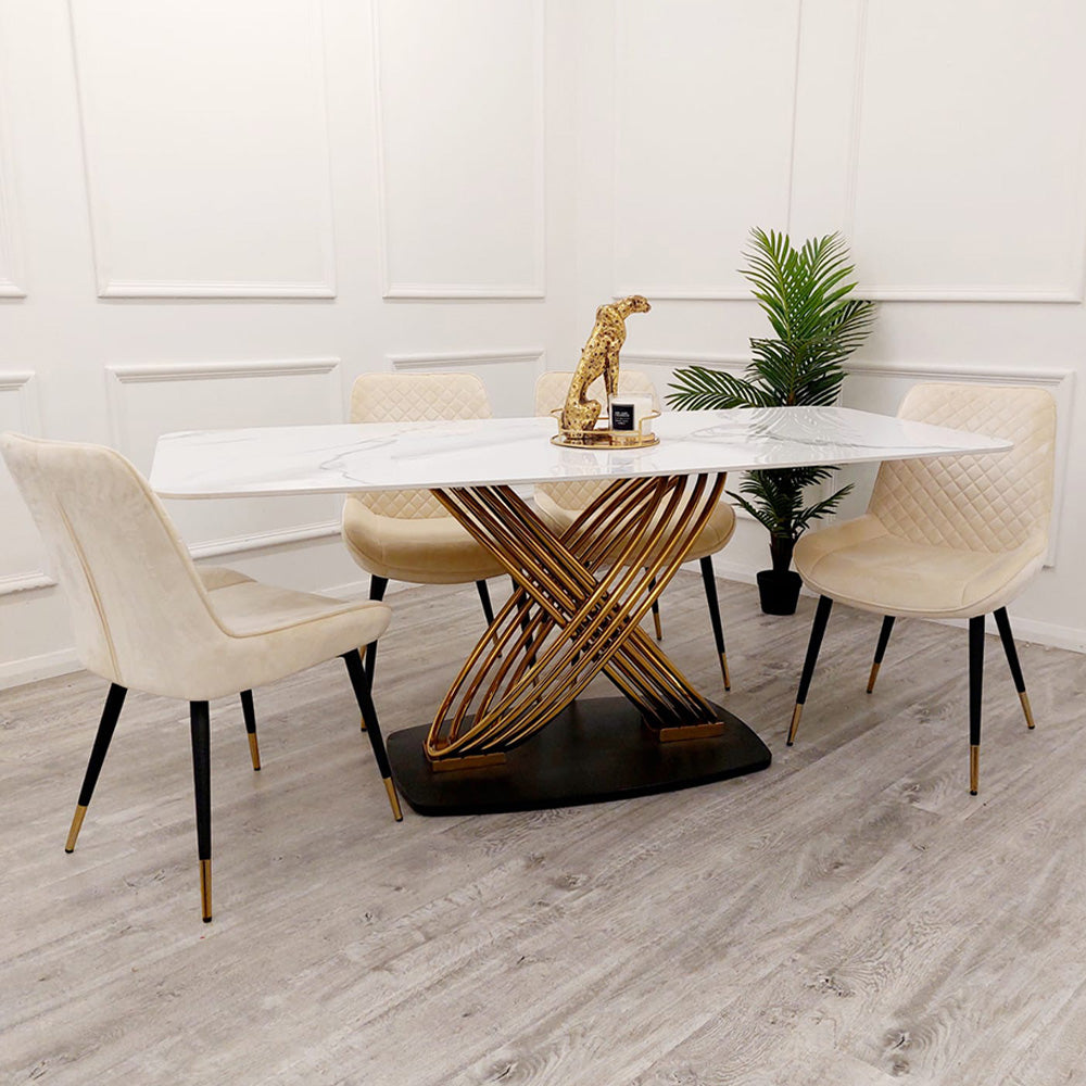 Orion Gold dining table with long white veined top and crossed gold-tone pedestal