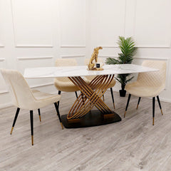 Orion Gold dining table with long white veined top and crossed gold-tone pedestal