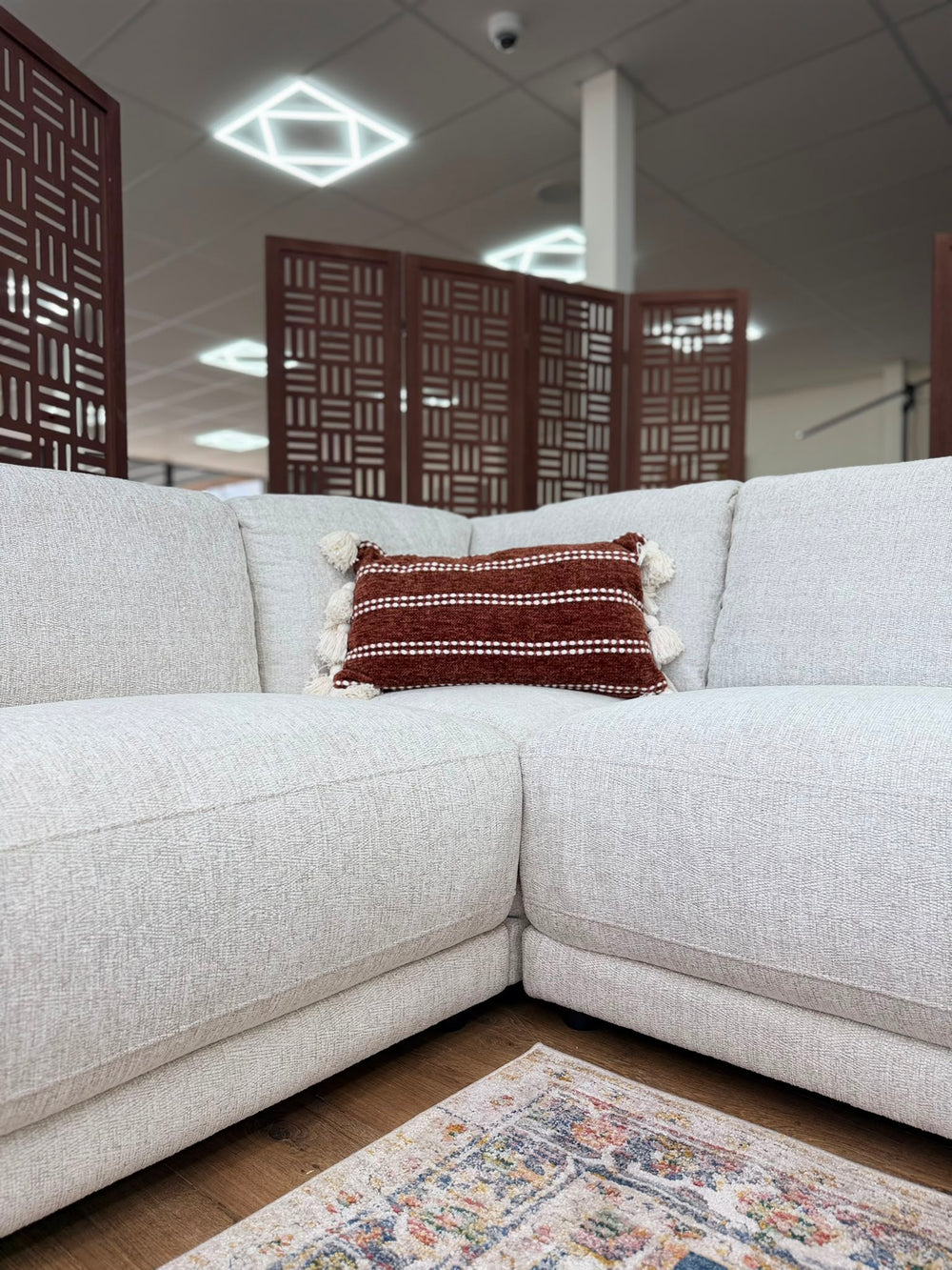 Marlow corner sofa interior corner with wide seat cushions and light gray upholstery.