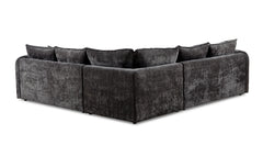 Large dark gray corner sofa viewed from behind, showing its L-shaped back and fabric upholstery.