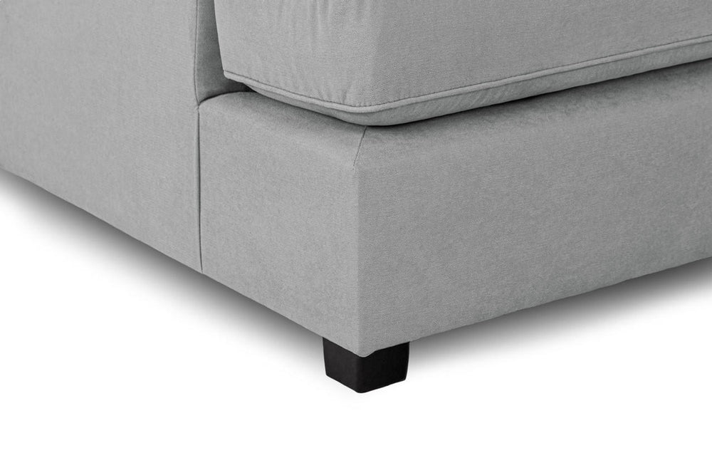 Close-up of gray sofa upholstery, stitched seat edge, and black foot