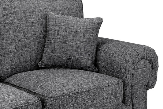 Close-up of gray woven sofa fabric, seat cushion, pillow, and rounded arm