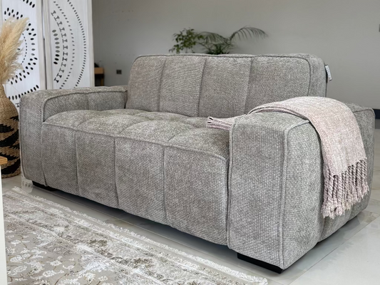 Two-seater sofa in gray textured fabric with broad arms and stitched seat and back panels
